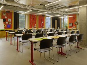 a large room with tables and chairs in it at 25hours Hotel Langstrasse in Zurich