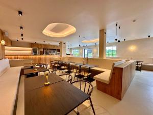 a restaurant with tables and chairs in a room at Camping Papillon Bouillon - Vakantiehuis Premium Rustige Locatie in Bouillon