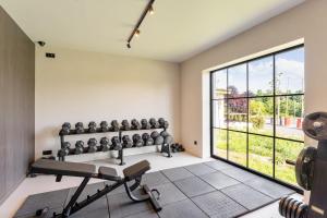 a gym with a bench and a large window at Camping Papillon Bouillon - Vakantiehuis Premium Rustige Locatie in Bouillon