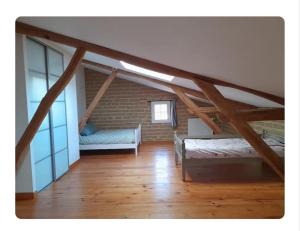 a attic room with a bed and a couch at Chambres d'hôtes le Brensole in Brens