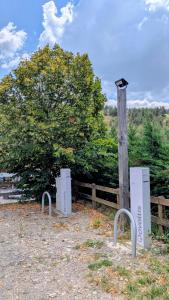 two white objects are sitting next to a wooden pole at Logis Hôtel restaurant La Remise in Le Bleymard +30 photos