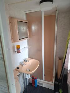 a bathroom with a sink and a shower at Mobilheim Lipno in Černá v Pošumaví