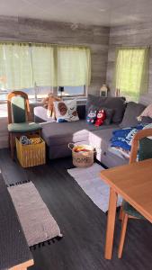 a living room with a couch and a table at Mobilheim Lipno in Černá v Pošumaví