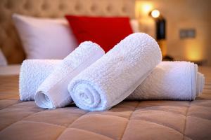 two rolls of towels on top of a bed at Aphrodeseum Romantic Suite in Taranto
