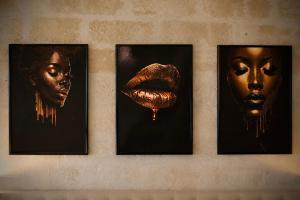 a group of four pictures hanging on a wall at Aphrodeseum Romantic Suite in Taranto
