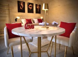 a living room with a table and a couch at Aphrodeseum Romantic Suite in Taranto