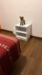 a white dresser with a figurine on top of it at All sur Cusco in Machu Picchu