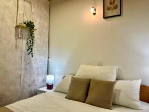a bedroom with a bed with white sheets and pillows at Damir Apartments Bonina in Jelsa