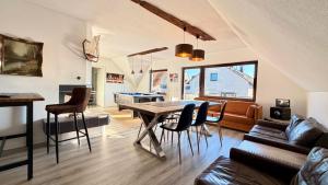 a kitchen and living room with a table and a couch at Whirlpool Kamin Sauna Herthasee in Eppenrod