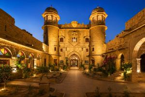 a large stone building with two towers at WelcomHeritage Mohangarh Fort in Sodākor