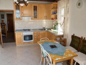 a kitchen with a table and a table and a couch at Rooms Jakirusa in Brela