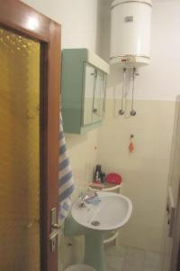 a bathroom with a sink and a toilet at Rooms Jakirusa in Brela
