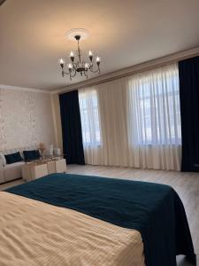 a large bedroom with a large bed and a chandelier at Liga Hotel and Restaurant in Shinuhayr +155 photos