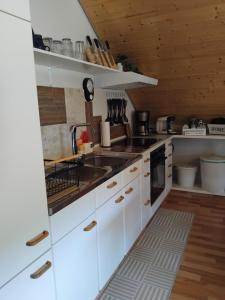 a kitchen with white cabinets and a sink at Ferienwohnung Monteurwohnung Pusteblume in Duderstadt
