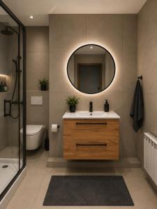 a bathroom with a sink and a mirror at Komfort Apartament Błonie 