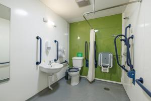 a hospital bathroom with a toilet and a sink at YHA Ilam Hall in Ashbourne +101 photos
