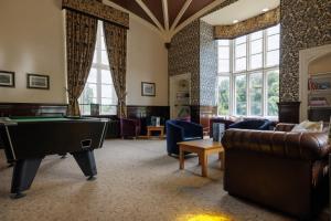 a large living room with a pool table in it at YHA Ilam Hall in Ashbourne