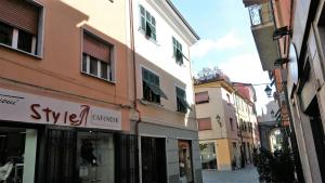 a narrow street with buildings in a city at Porta Romana in Sarzana