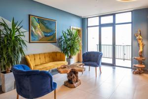 a living room with a couch and two chairs at GINO Seaside Tbilisi, Trademark Collection by Wyndham in Tbilisi City