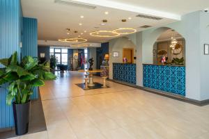 a lobby of a hospital with a table and plants at GINO Seaside Tbilisi, Trademark Collection by Wyndham in Tbilisi City