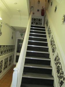a staircase in a building with black and white tiles at Paramount Hotel in Nottingham