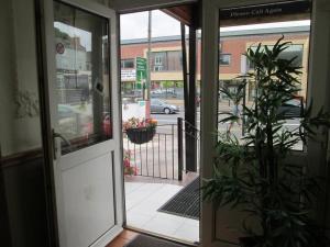 an open door of a store with a potted plant at Paramount Hotel in Nottingham