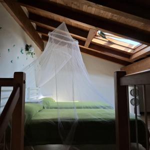 a bedroom with a bed with a net on it at Casa Luce e Aria in Colico