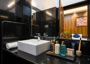 a bathroom with a white sink and a mirror at Hotel Toffu safari in Jaisalmer +58 photos