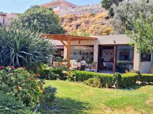 a house with a patio and a garden at Villa Dino in Kalithies