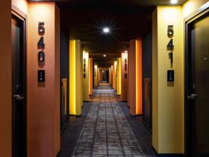 a long hallway with orange and yellow walls at ibis Almaty Jetisu in Almaty