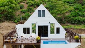 a small white house with a swimming pool at Dover View Villas in Carriacou
