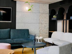 a living room with a couch and a table at ibis Styles ST Pauls Bay Malta in St. Paul's Bay