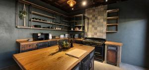 a kitchen with a wooden counter top in a room at Le Grant Guesthhouse in Kroonstad