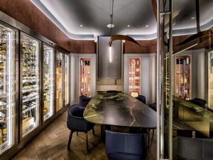 a dining room with a table and chairs at Palazzo Tirso MGallery Cagliari in Cagliari +177 photos