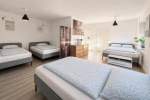 a bedroom with two beds and a room with two beds at Whirlpool Kamin Sauna Herthasee in Eppenrod