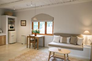 a living room with a couch and a table at The Oak Cottage in Wellington