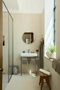 a bathroom with a sink and a mirror at Hôtel du Parc in Arles +29 photos