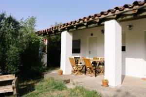a patio with a table and chairs on a house at Camping Armalygal in Murillo de Gállego