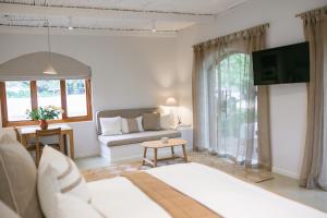 a living room with a couch and a tv at The Oak Cottage in Wellington