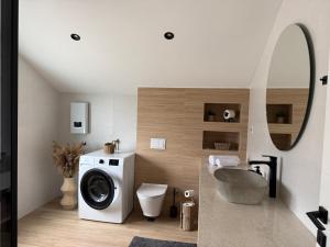 a bathroom with a washing machine and a toilet at Sunny HILL in Trebinje +27 photos