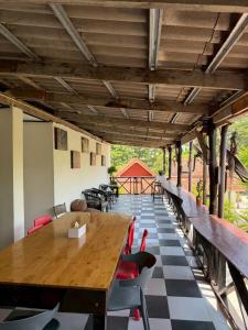 a dining room with a wooden table and chairs at Mookboonchu Guesthouse ,Kohmook Trang in Ko Mook