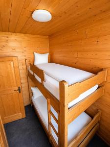 a cabin with two bunk beds in it at Haus am Anger Top 42 in Königsleiten