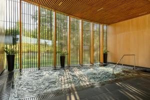 a room with a hot tub inside of a building at Evergreen Health Longevity Residence in Kehidakustány