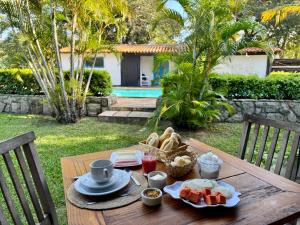 a wooden table with food on top of it at Peixe Crew Manguinhos in Búzios