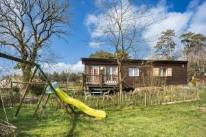 a playground with a slide in front of a house at Container Maritime Montagne Noire in Fontiers-Cabardès