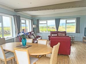 a living room with a table and a couch at Driftwood in Mainsriddle