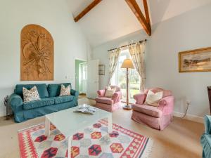 a living room with two couches and a table at The Fishing Lodge in Amesbury