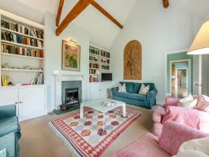 a living room with two couches and a fireplace at The Fishing Lodge in Amesbury