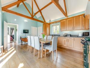 a kitchen and dining room with a table and chairs at The Fishing Lodge in Amesbury