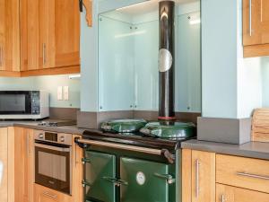 a kitchen with an old green stove in it at The Fishing Lodge in Amesbury +21 photos